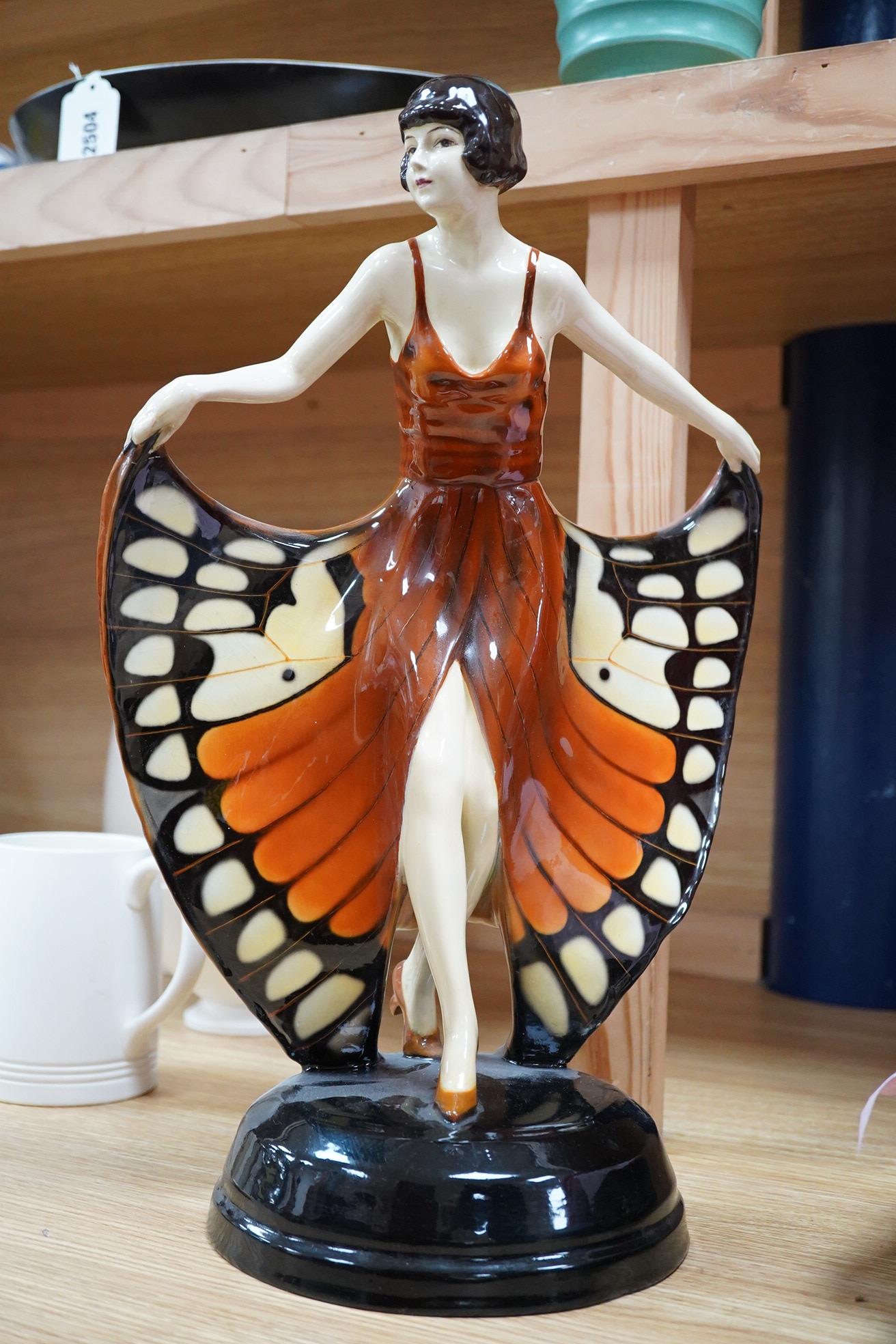 A Lorenzl Goldscheider butterfly dancer figurine, stamped to the base, restored, 42cm high